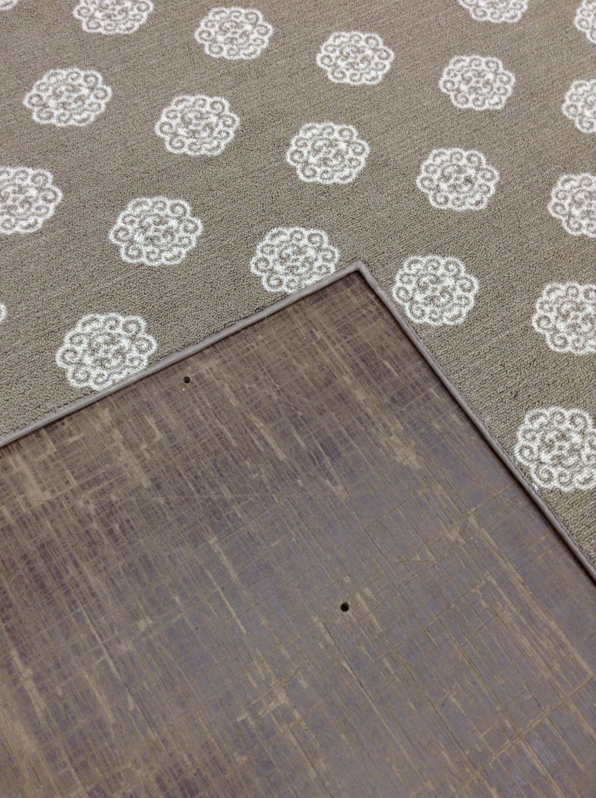 Corner of a bound carpet rug showing the binding tape