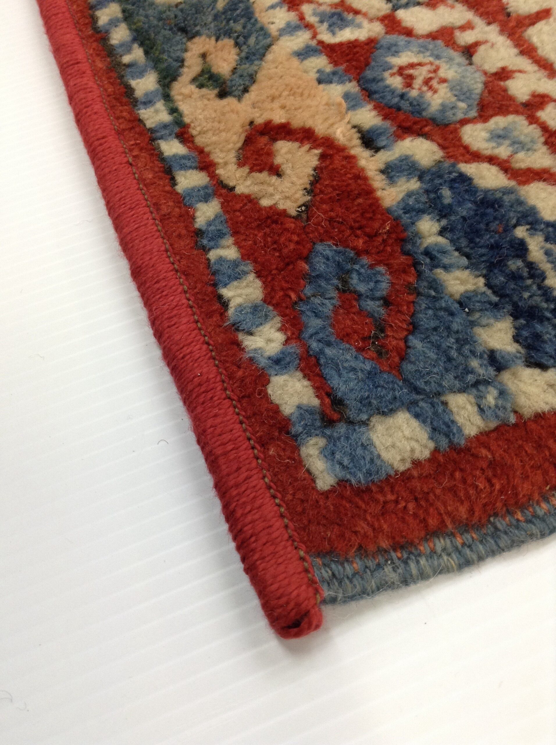 Serged edge on a red patterned rug
