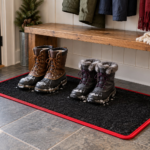 Winter boot tray mat in Coal Black carpet with red binding in a mudroom